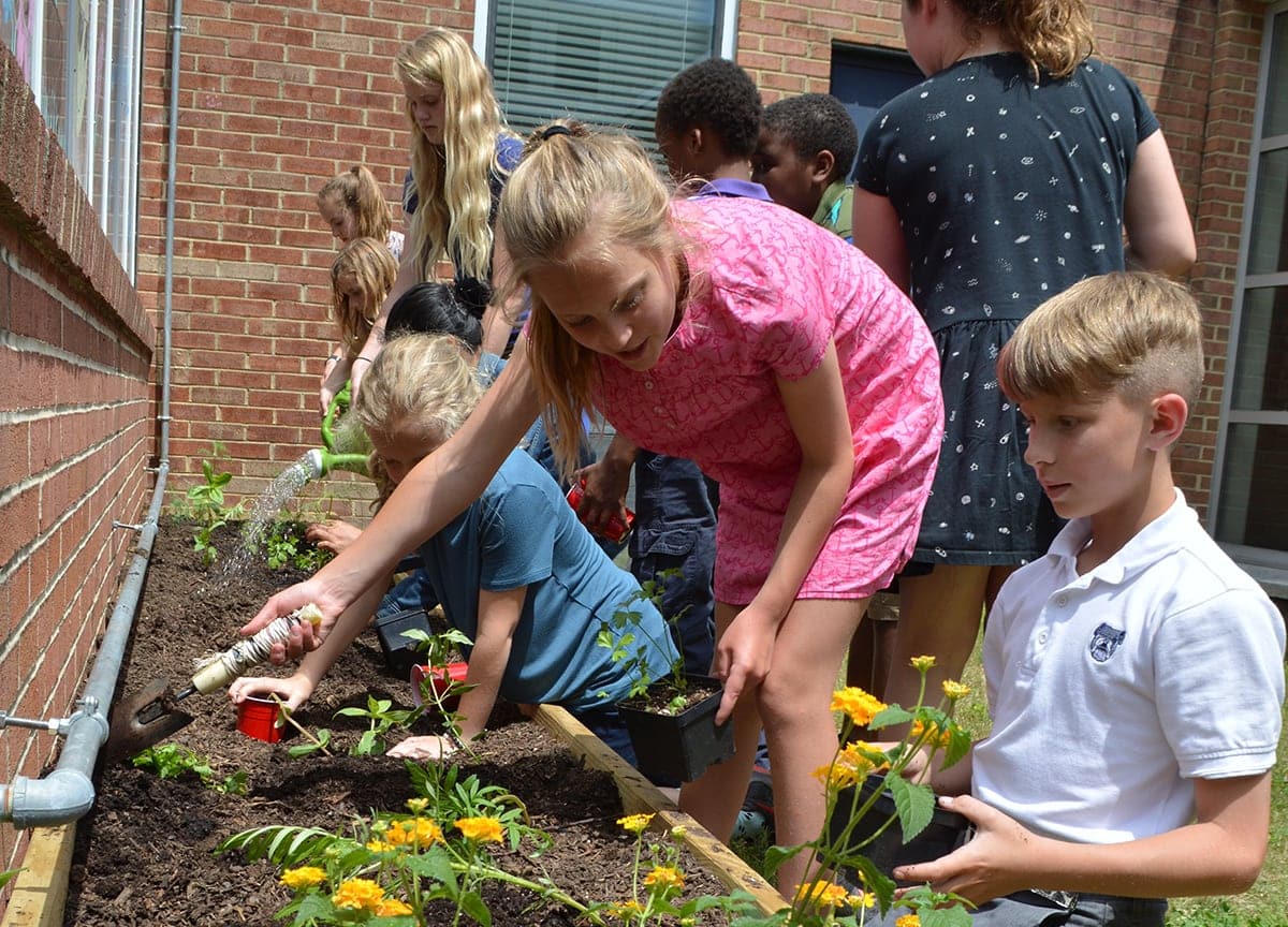 young students gardening